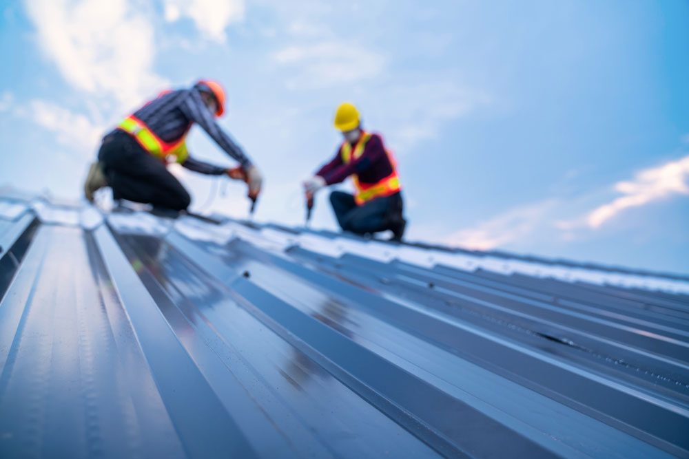 workers working on a metal roof