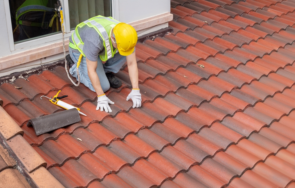 worker inspecting a roof