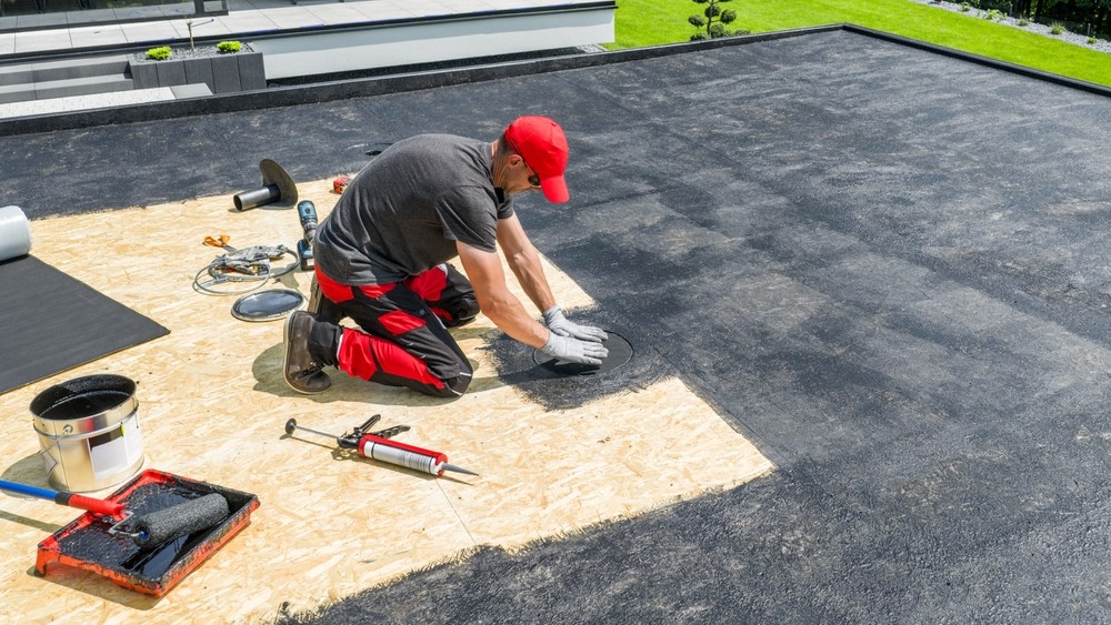 worker installing a flat roof
