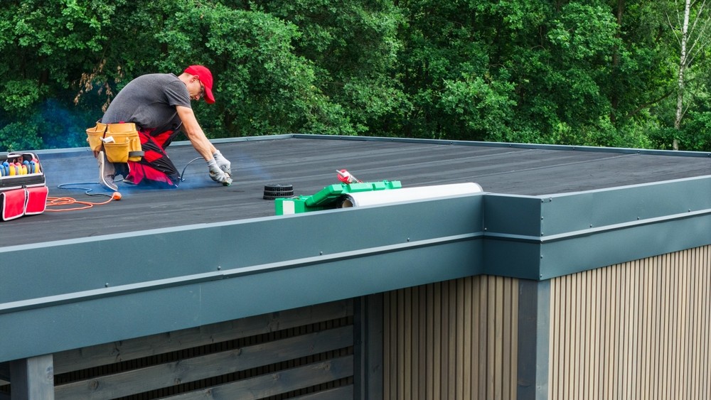 worker working on a flat roof