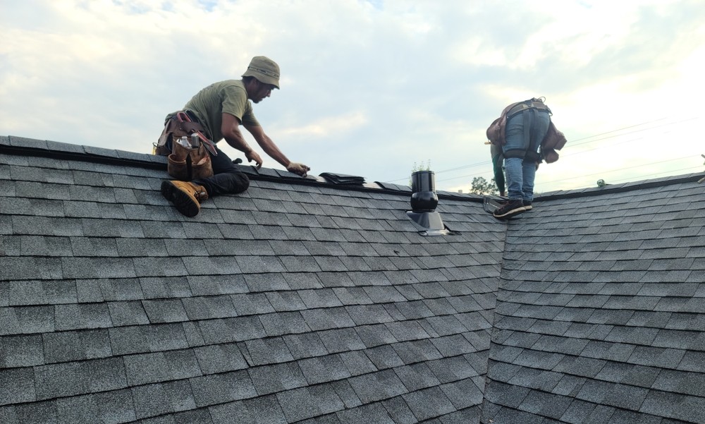 2 workers working on a roof