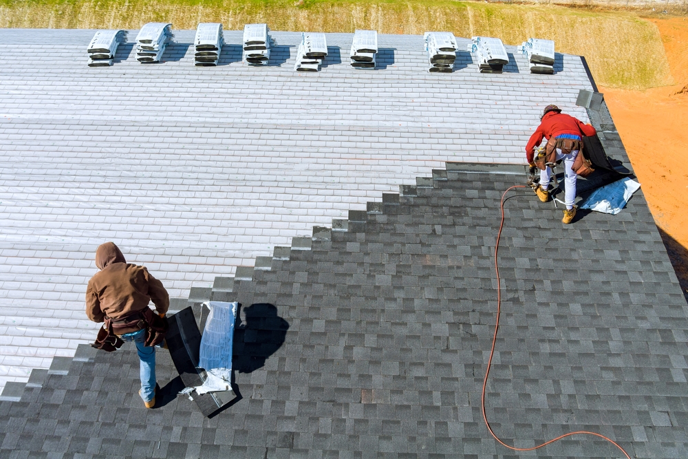 aerial shot of workers laying roofing